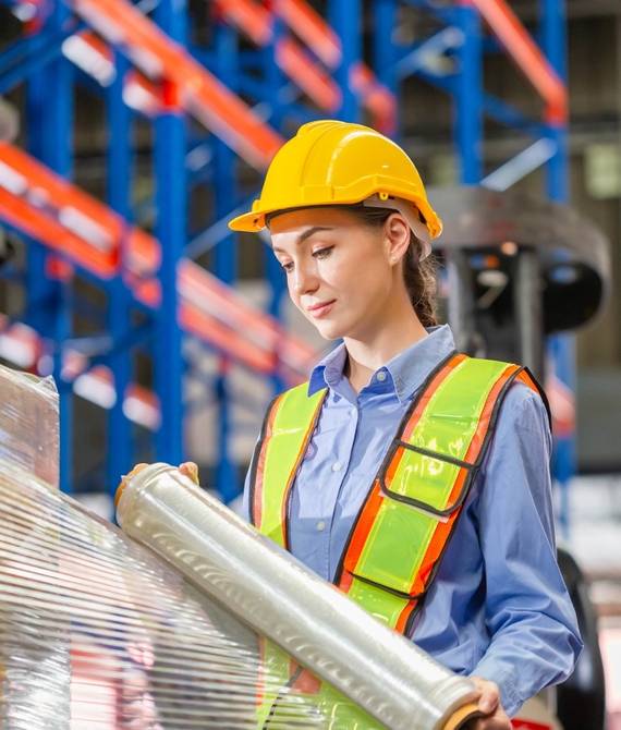 Female,Worker,Wrapping,Boxes,In,Stretch,Film,At,Warehouse,,Worker